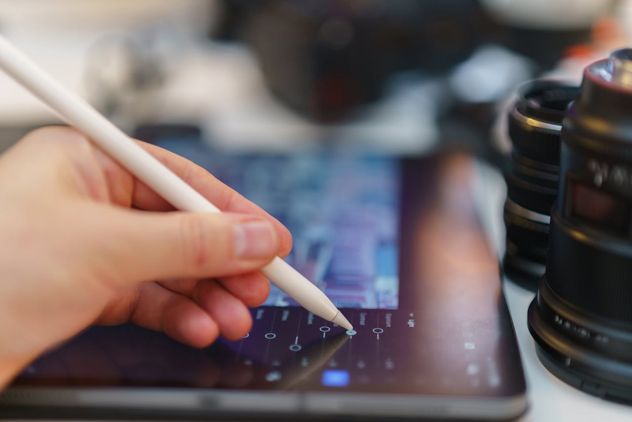 Close-up of digital design work using a tablet and stylus, showcasing creativity and technology in action.