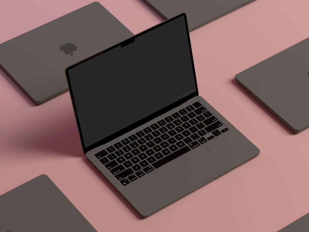 a-laptop-computer-sitting-on-top-of-a-pink-surface-nzimnrab-ti